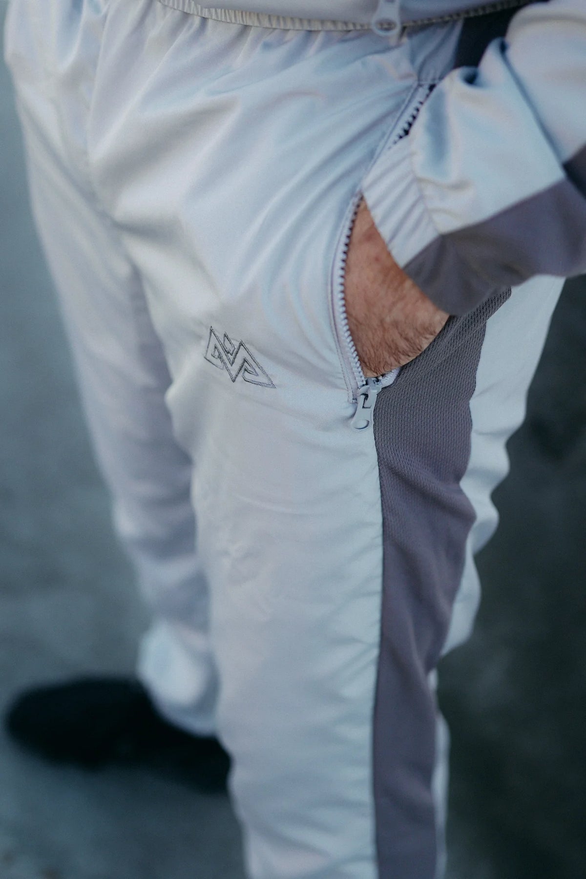 Graue Trainingshose mit Reißverschlusstasche und gesticktem Logo