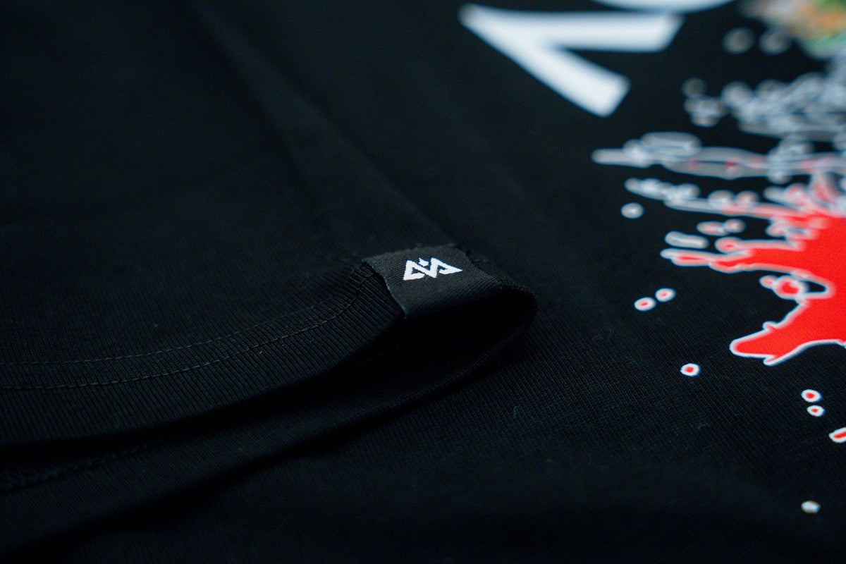 Close-up of woven sleeve logo on black T-shirt
