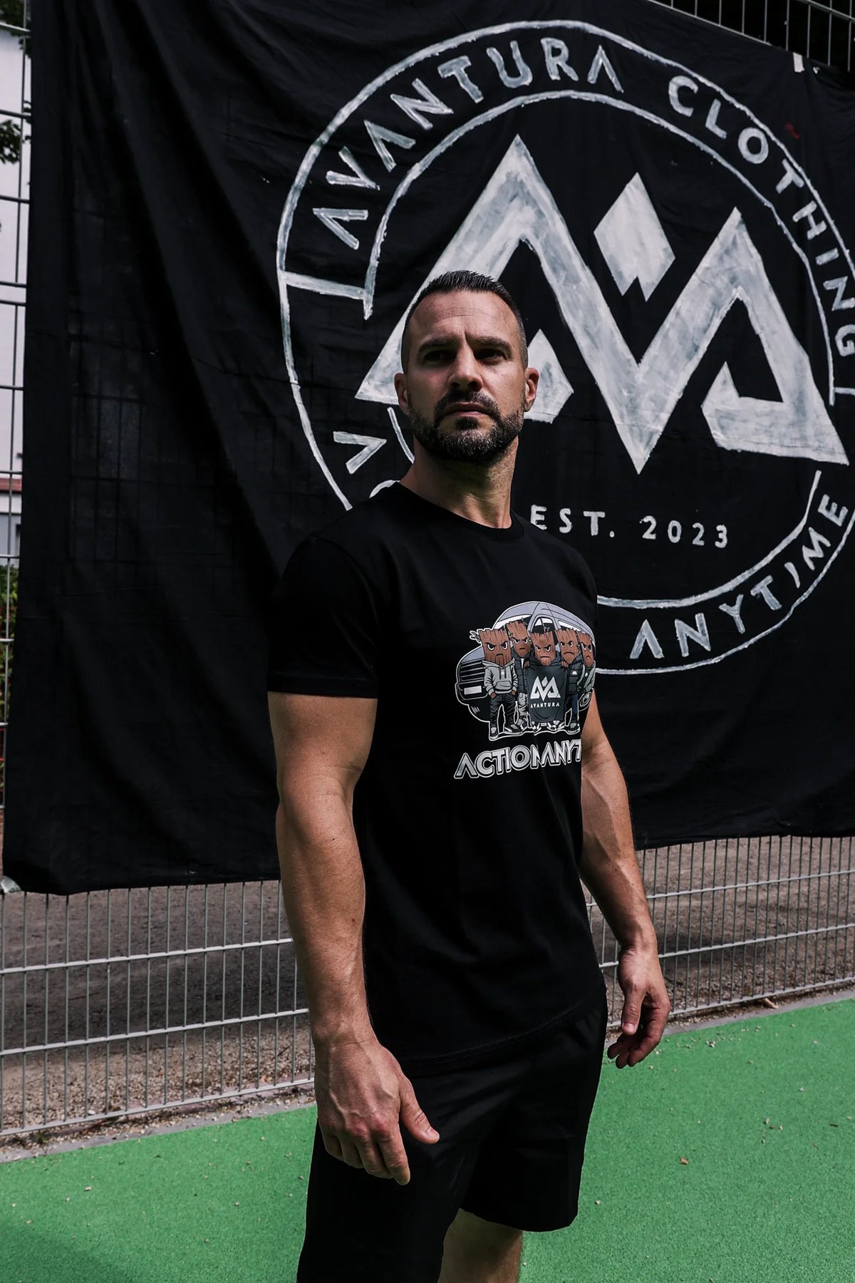 Black short-sleeve T-shirt with bold Action Anytime front graphic