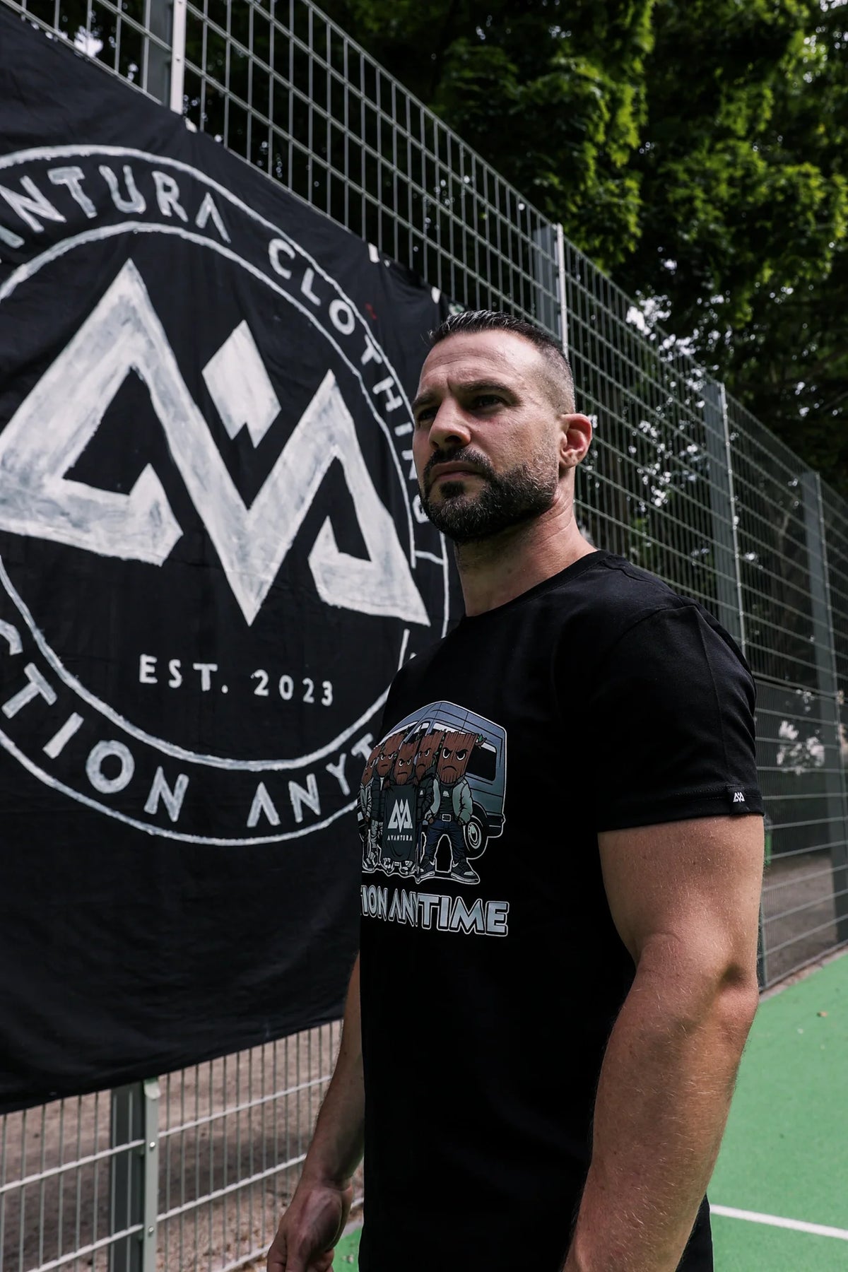 Avantura black T-shirt featuring tree-headed characters and van design