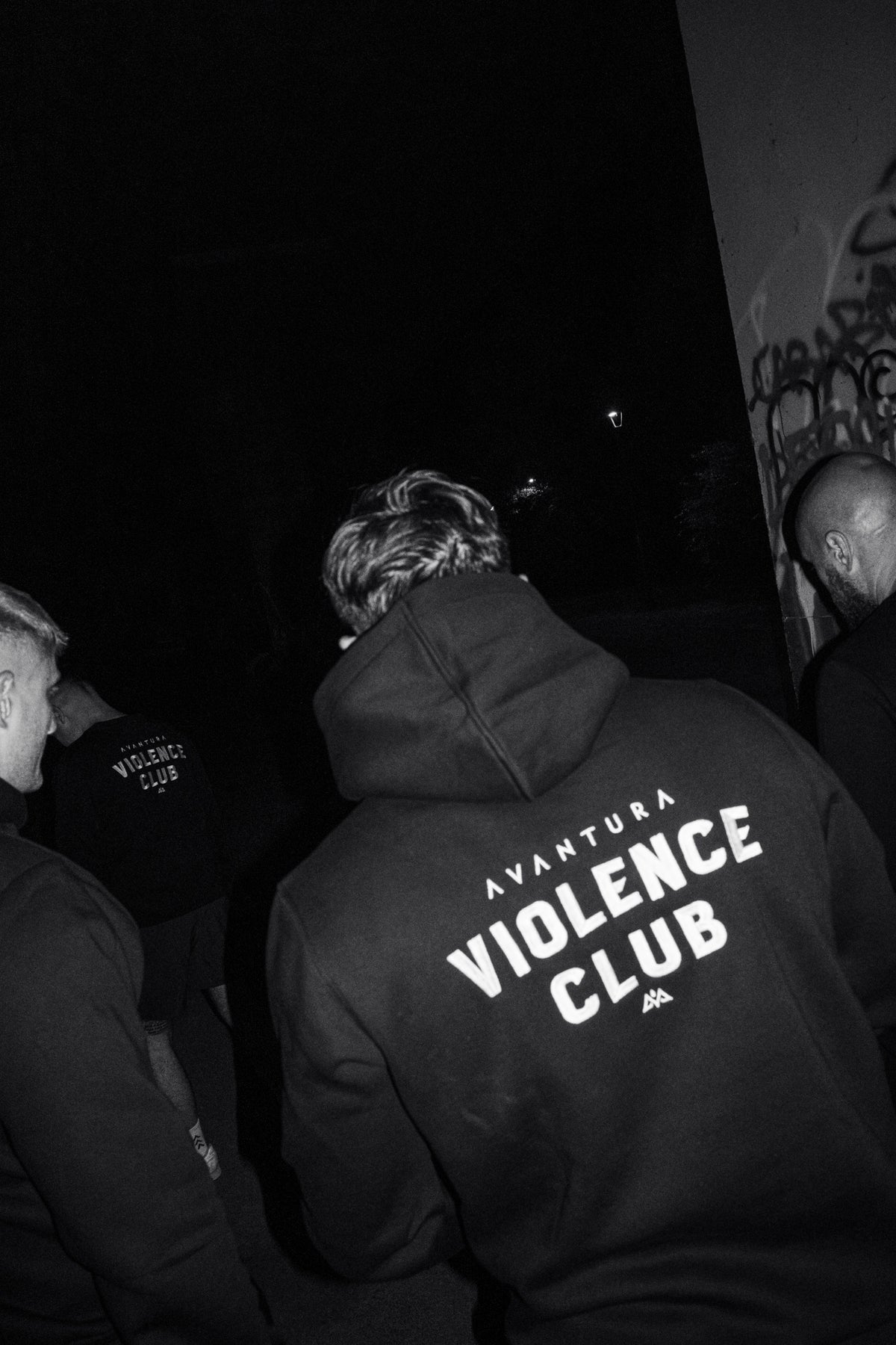 Back print of black hoodie reading Avventura Violence Club